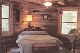 The master bedroom has a view out two windows.